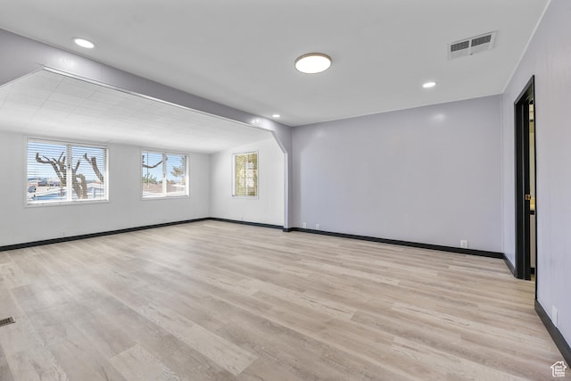 unfurnished room featuring baseboards, light wood-style floors, and recessed lighting
