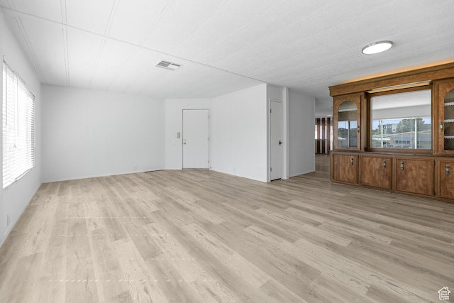 unfurnished room with light wood finished floors