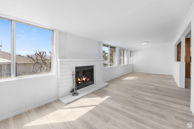 unfurnished living room featuring a fireplace and wood finished floors