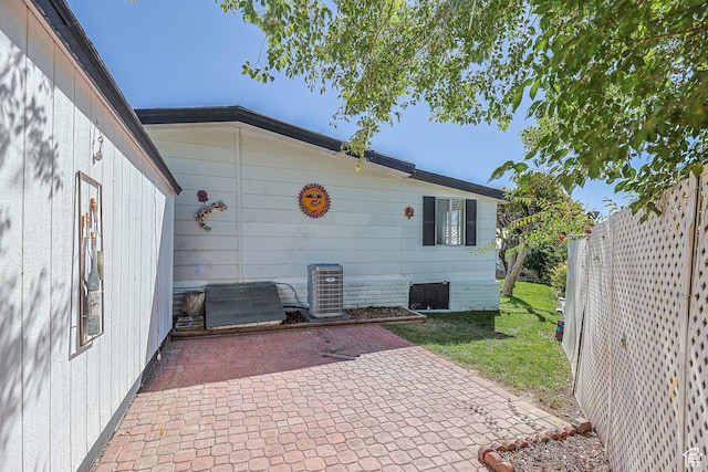 view of patio with cooling unit and fence