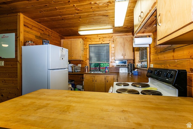 kitchen with range with electric stovetop, freestanding refrigerator, wooden walls, wood ceiling, and butcher block counters