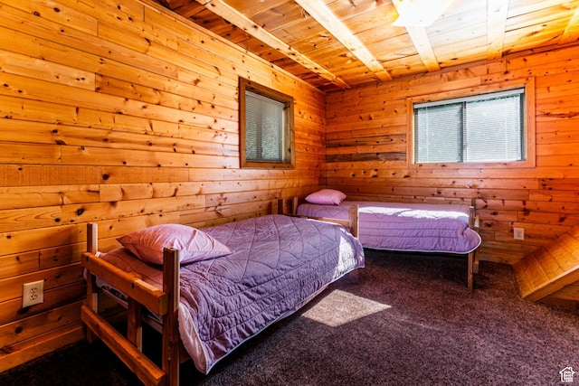 carpeted bedroom with wooden ceiling and wooden walls