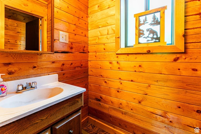 bathroom with wood walls and vanity