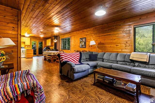 living area with wooden ceiling and wood walls