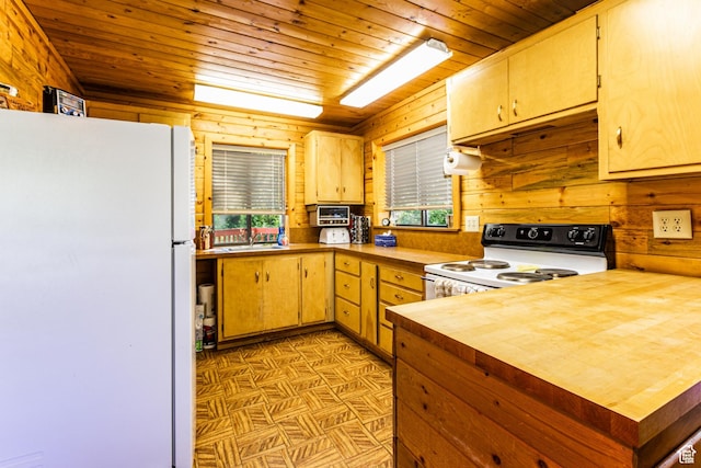 kitchen with white appliances, wood ceiling, wood walls, butcher block countertops, and a sink