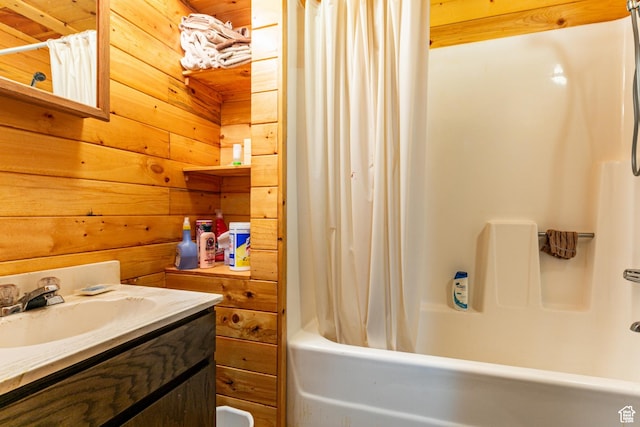 bathroom featuring shower / bath combo with shower curtain, vanity, and wood walls