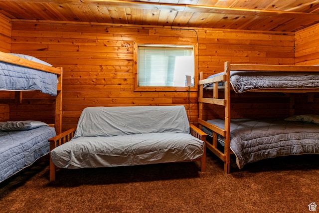 bedroom featuring wood ceiling, wood walls, and carpet floors