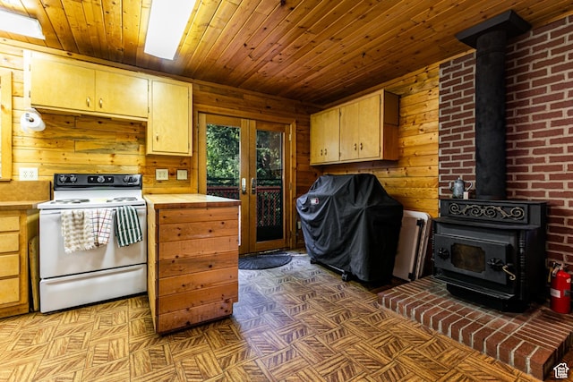 kitchen featuring electric range, a wood stove, wood ceiling, wood walls, and french doors