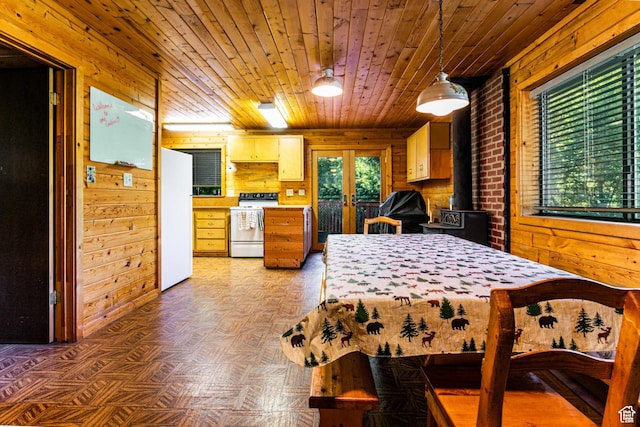 bedroom with freestanding refrigerator, french doors, wood walls, and wood ceiling