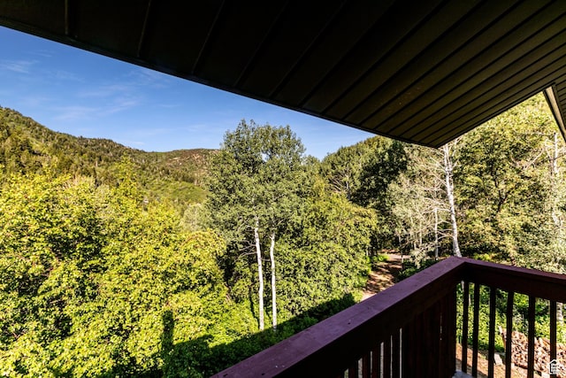 balcony featuring a view of trees