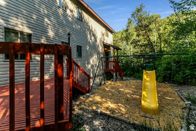 view of yard featuring a deck and a playground