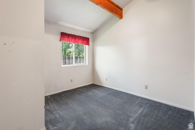 unfurnished room with dark colored carpet and baseboards