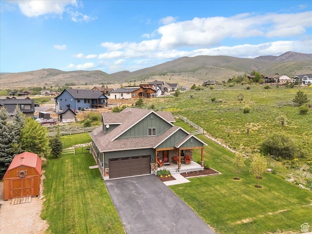 4026 E 4325 N, Eden, UT 84310 - view of front of home with board and batten siding, covered porch, a mountain view, and roof with shingles