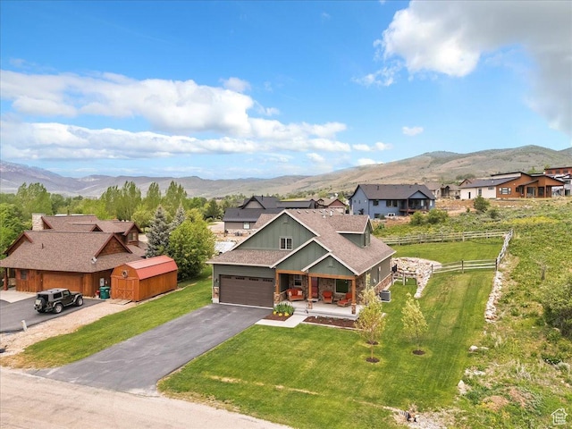 4026 E 4325 N, Eden, UT 84310 - view of front of house featuring a mountain view, a porch, driveway, board and batten siding, and a garage