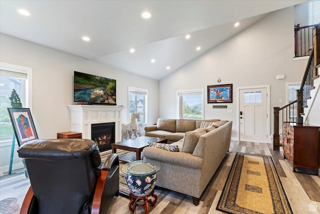 4026 E 4325 N, Eden, UT 84310 - living room with recessed lighting, stairs, a glass covered fireplace, light wood-style flooring, and high vaulted ceiling