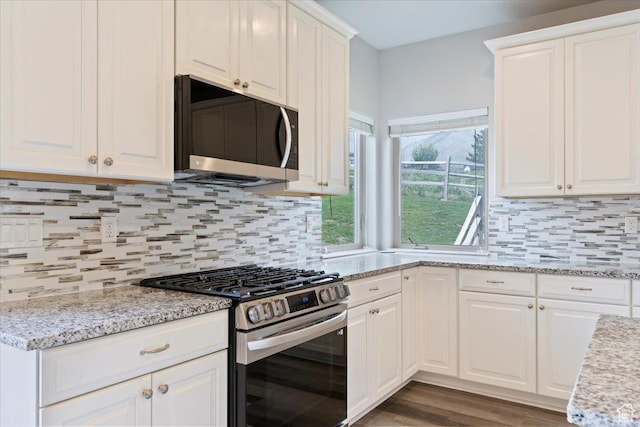 4026 E 4325 N, Eden, UT 84310 - kitchen with stainless steel appliances, white cabinets, backsplash, and light stone counters