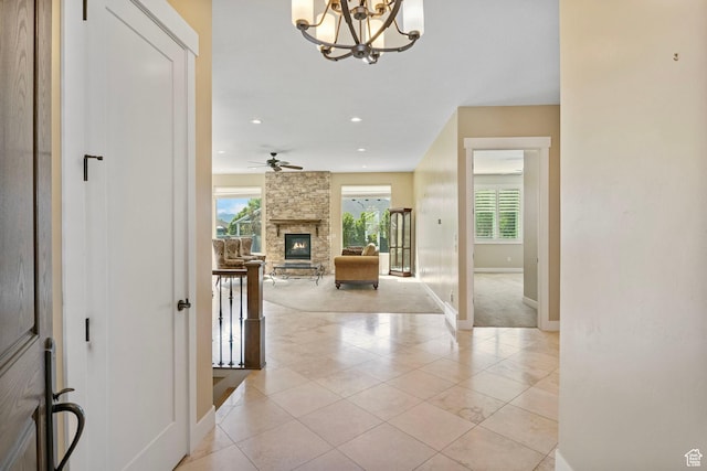 corridor with healthy amount of natural light, baseboards, a chandelier, light tile patterned floors, and recessed lighting