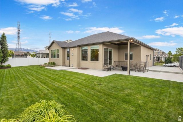 rear view of house with stucco siding and a patio area