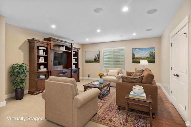 living room featuring baseboards and recessed lighting