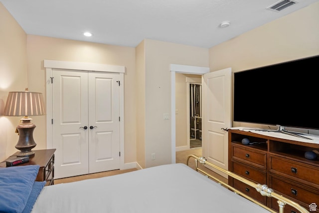 bedroom featuring a closet, recessed lighting, and baseboards
