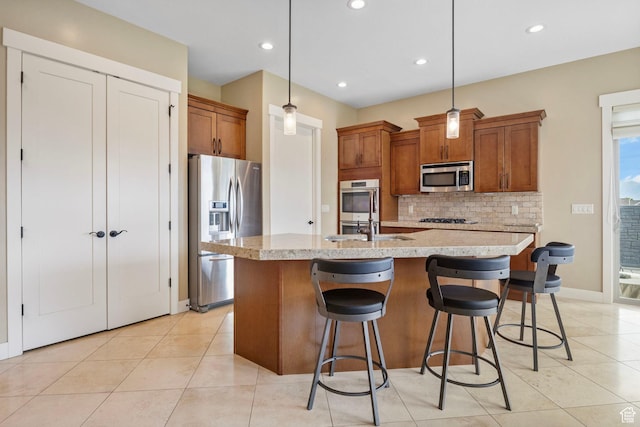 kitchen with appliances with stainless steel finishes, brown cabinets, backsplash, light tile patterned flooring, and recessed lighting