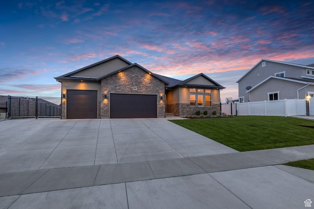 modern home with stone siding, an attached garage, concrete driveway, and stucco siding