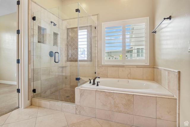 full bath featuring a garden tub, a shower stall, and tile patterned flooring