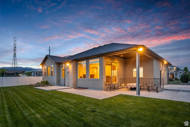 back of house with a patio area and stucco siding