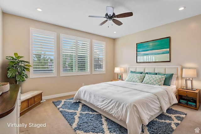 bedroom featuring light colored carpet, baseboards, recessed lighting, and ceiling fan