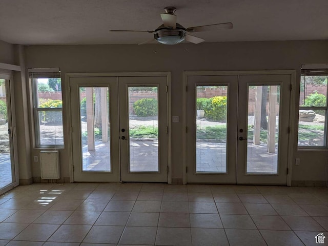 doorway to outside featuring french doors, plenty of natural light, and light tile patterned flooring