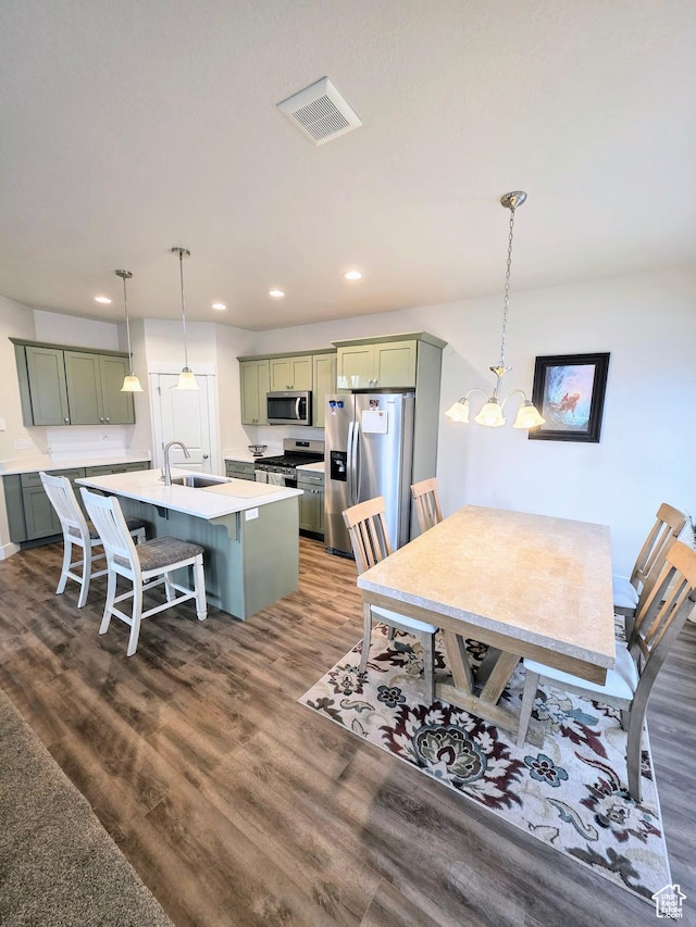 dining space featuring dark wood-style flooring, recessed lighting, and a chandelier