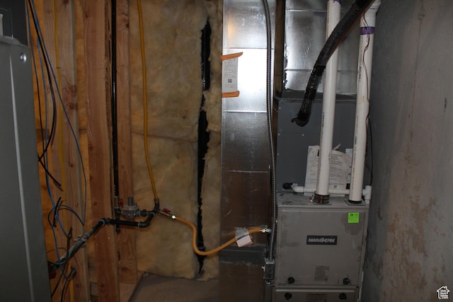 utility room featuring heating unit