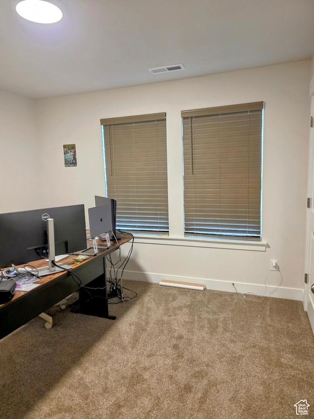 carpeted office space with baseboards