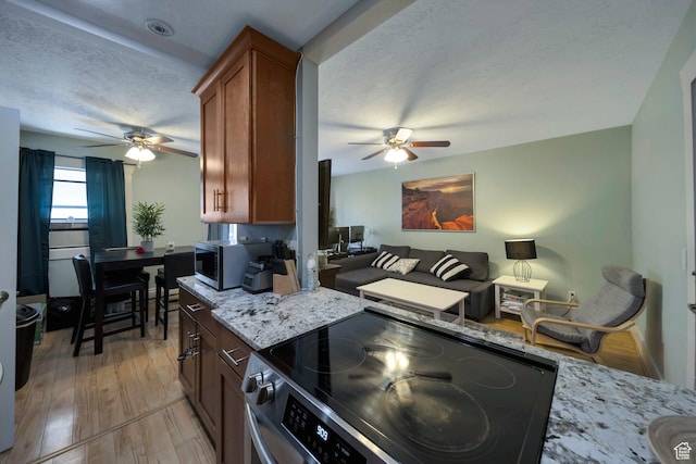 125 E 1st Ave Unit 206, Salt Lake City, UT 84103 - kitchen featuring electric stove, a ceiling fan, stainless steel microwave, light wood-type flooring, and a textured ceiling