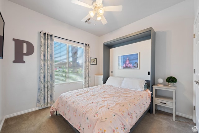 carpeted bedroom featuring baseboards and a ceiling fan