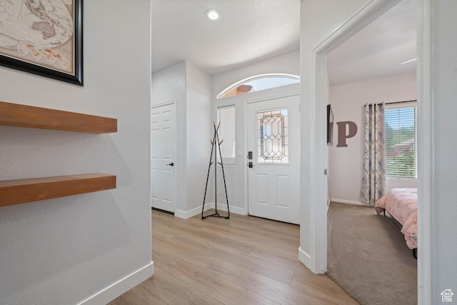entryway featuring light wood finished floors and baseboards