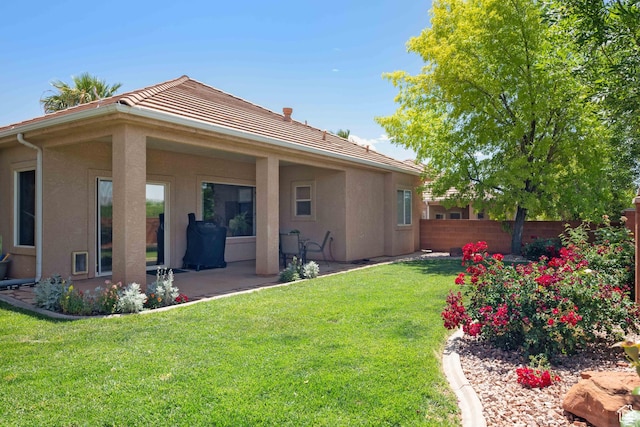 back of property featuring stucco siding, a patio, and a tile roof