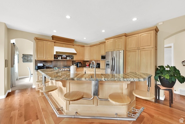 857 E 3250 N, North Ogden, UT 84414 - kitchen with appliances with stainless steel finishes, arched walkways, light brown cabinetry, baseboards, and recessed lighting