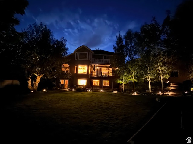 857 E 3250 N, North Ogden, UT 84414 - back of house at night with a balcony and stucco siding