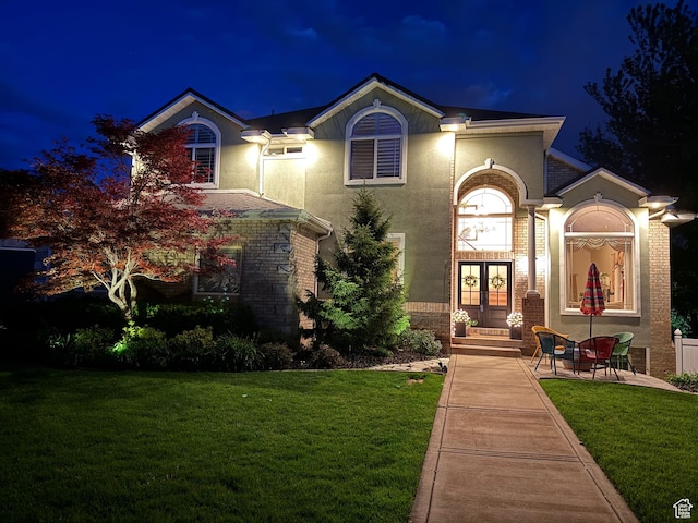 857 E 3250 N, North Ogden, UT 84414 - view of front of house featuring french doors, stucco siding, a yard, and brick siding