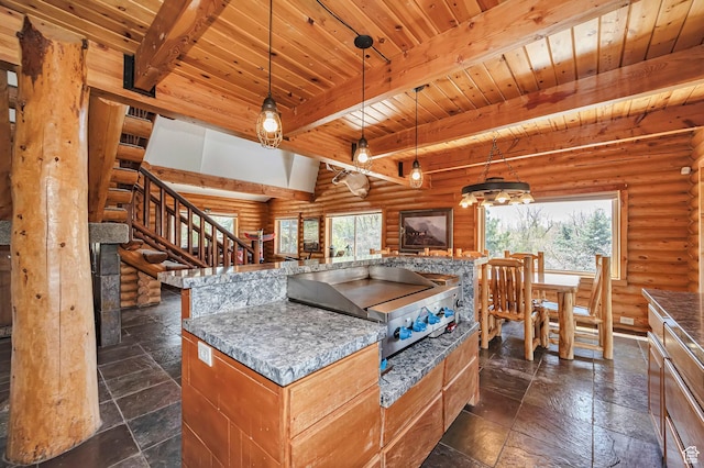 kitchen with rustic walls, beamed ceiling, wooden ceiling, stone tile floors, and open floor plan