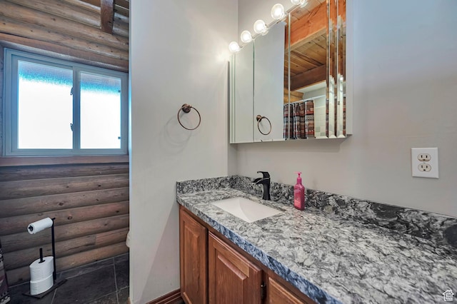 bathroom featuring log walls, vanity, and wooden ceiling