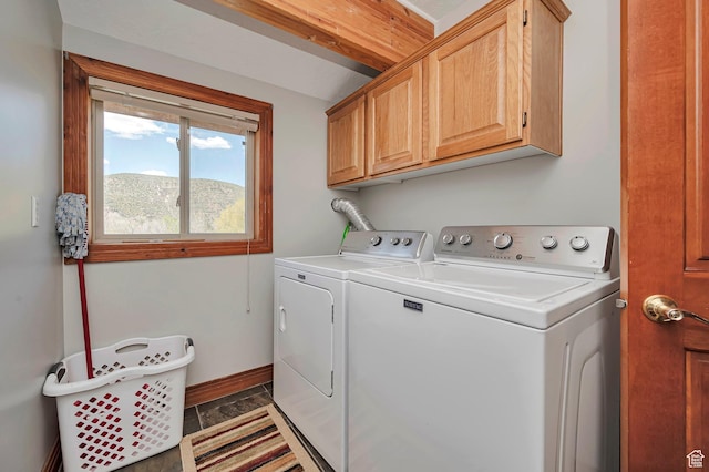 laundry area featuring cabinet space, washer and clothes dryer, and baseboards