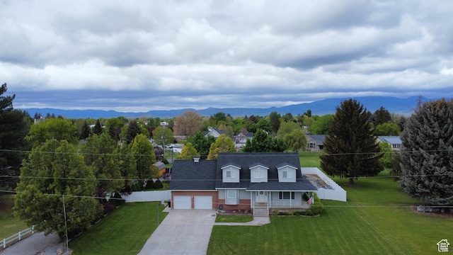 135 N 3rd E, Preston, ID 83263 - view of front facade featuring concrete driveway, a mountain view, a garage, and a porch