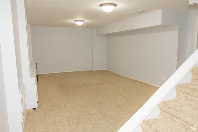 135 N 3rd E, Preston, ID 83263 - finished below grade area featuring light colored carpet, stairs, and a textured ceiling