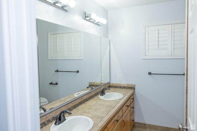 135 N 3rd E, Preston, ID 83263 - bathroom with double vanity, toilet, and tile patterned flooring