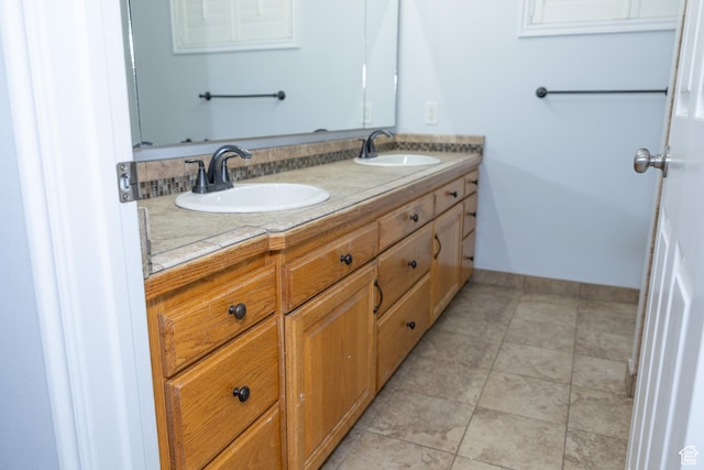 135 N 3rd E, Preston, ID 83263 - full bathroom featuring double vanity, tile patterned floors, and baseboards