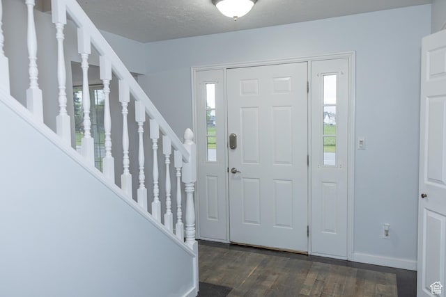 135 N 3rd E, Preston, ID 83263 - foyer entrance with dark wood-type flooring, stairs, and baseboards