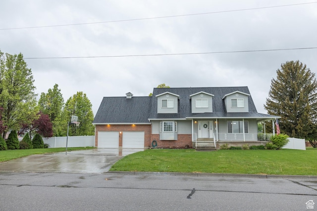 135 N 3rd E, Preston, ID 83263 - cape cod-style house with driveway, covered porch, a garage, and brick siding