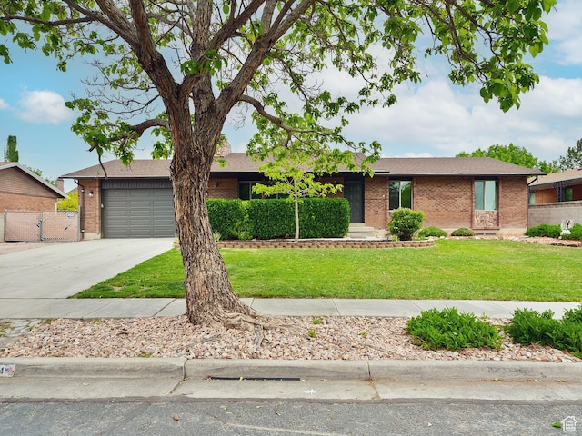 single story home with brick siding, concrete driveway, and an attached garage
